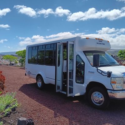 a bus parked on the side of a dirt road