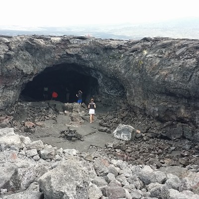 a person standing on a rocky beach
