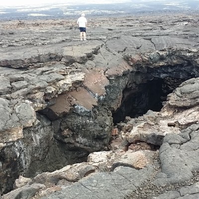 a man standing on a rocky beach