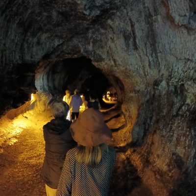 a person standing in front of a cave
